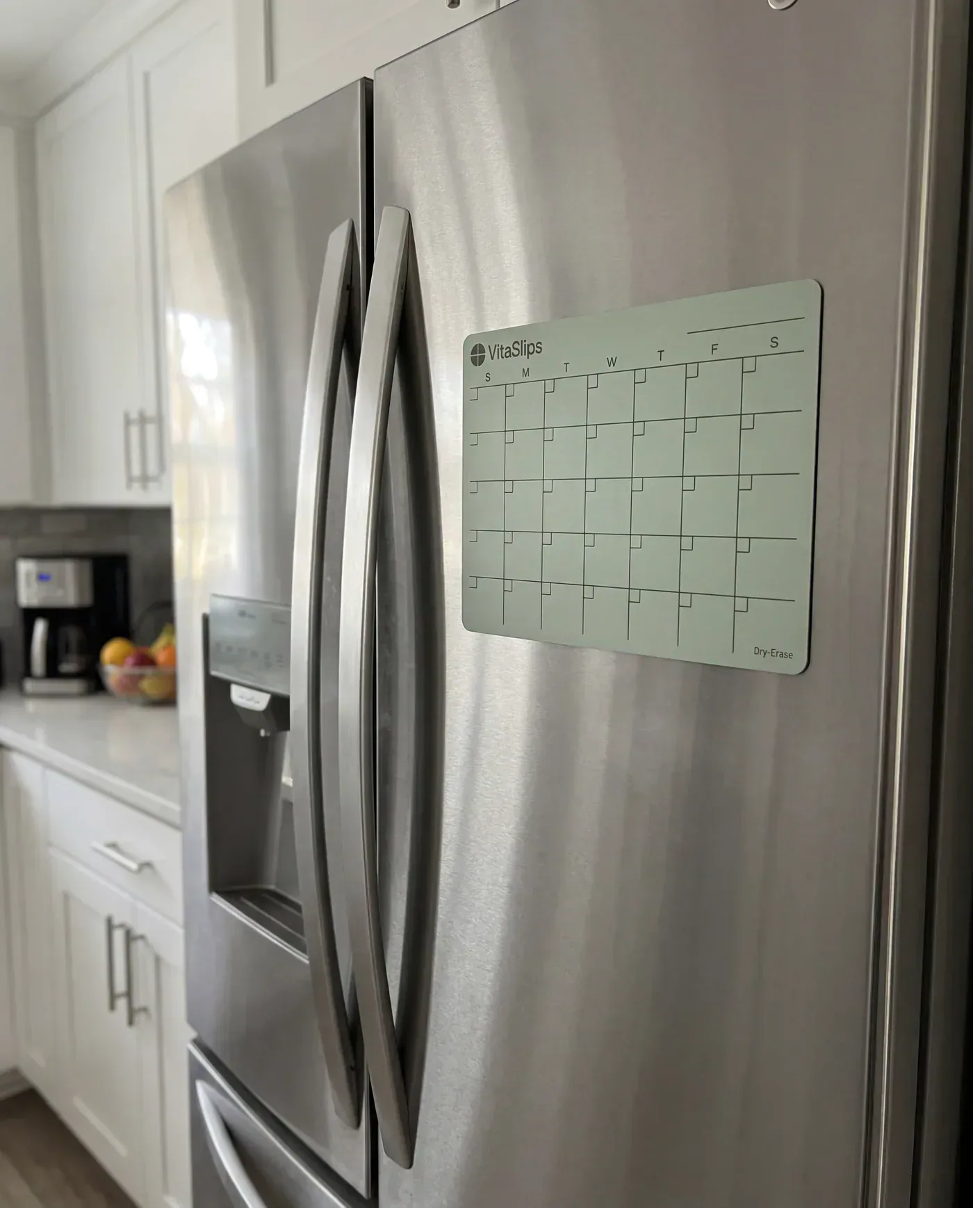 VitaSlips Wellness Calendar on a refrigerator — included with your first VitaSlips subscription